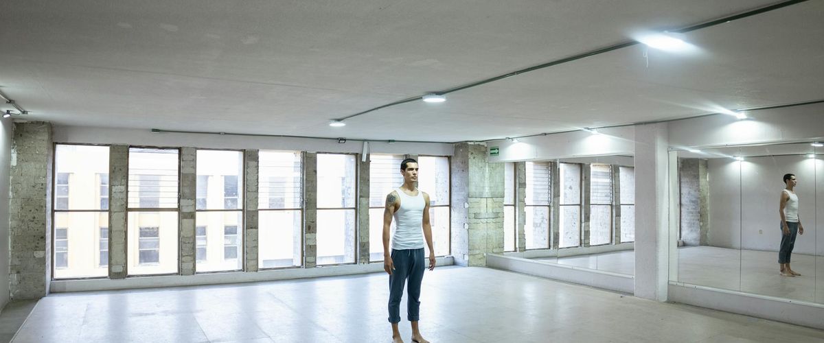 Interior of a calm and spacious yoga studio with soft lighting.